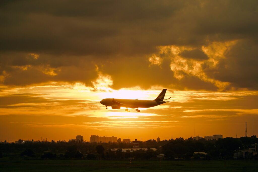 Airplane landing at sunset